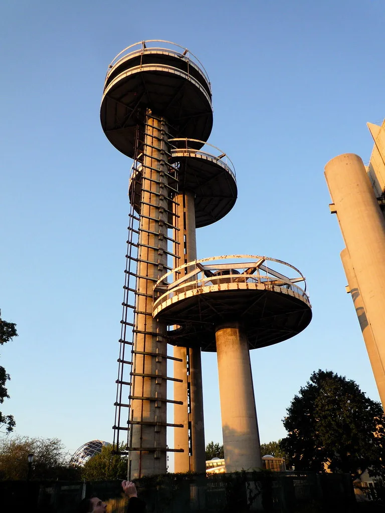 Concrete towers with rusty circular platforms and vertical remnants of a lifting mechanism.