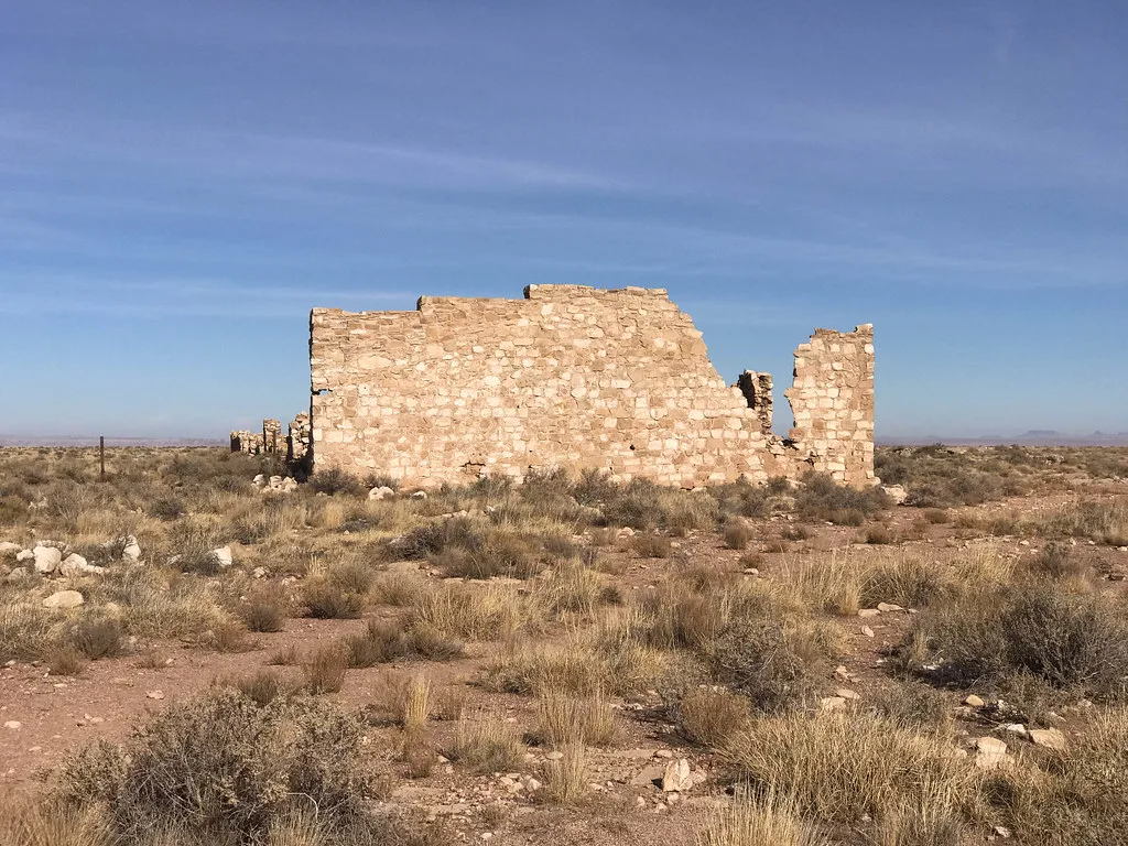 Ruined walls of the former Volz trading post in an arid landscape.