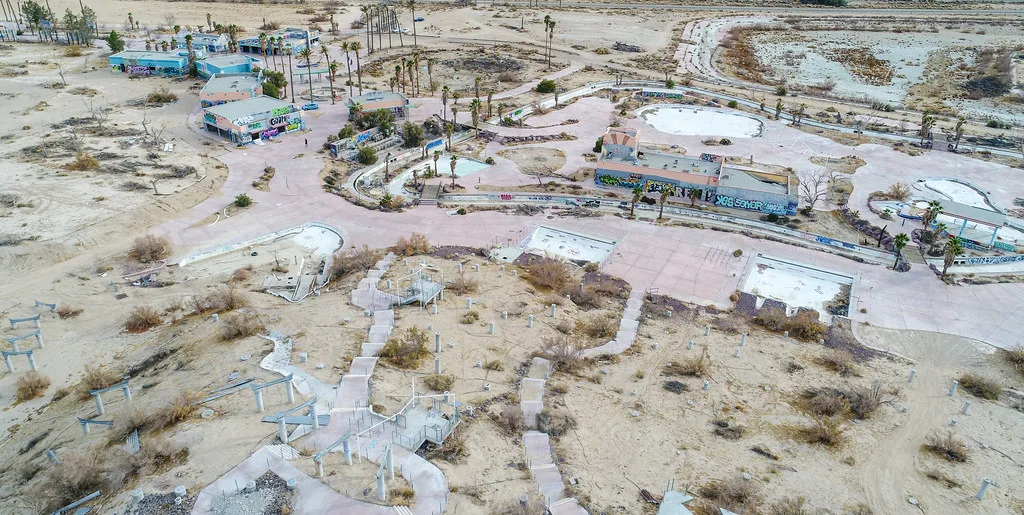 Aerial view of a former water park with empty pools.