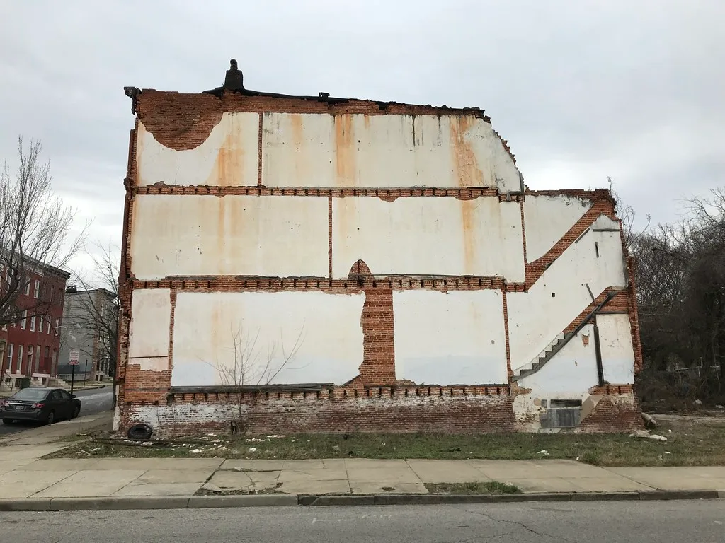 Remaining brick wall of a building with traces of floors and a staircase.