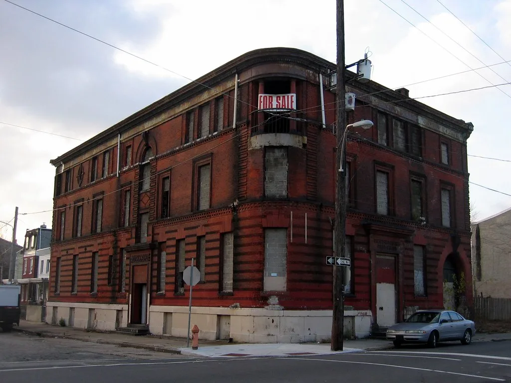 Red brick corner building with sealed windows.