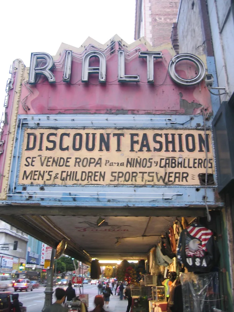 Pink marquee of the Rialto Theatre above a shop frontage.