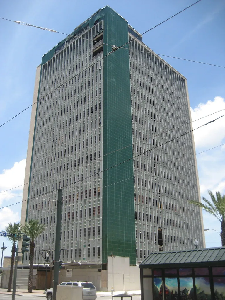 Old tower with missing glazing and a boarded ground floor.