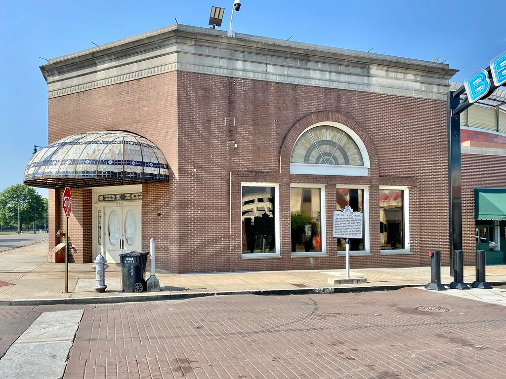 Brick building at Beale Street and 4th Street in Memphis with a glass canopy.