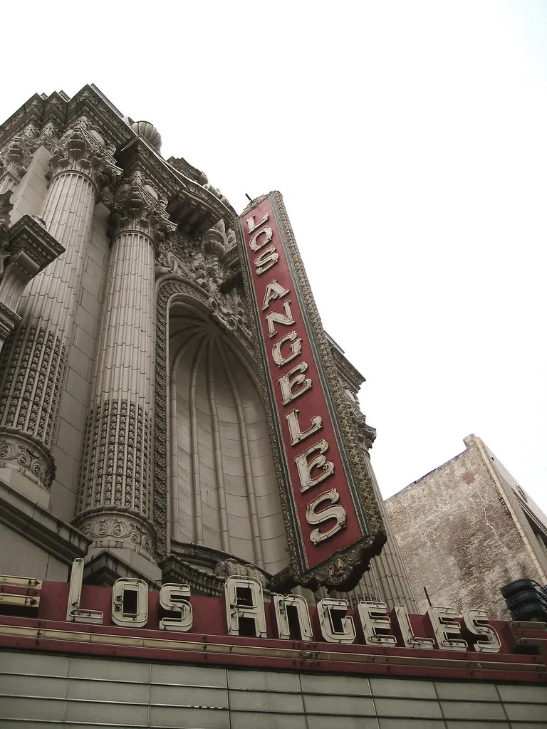 Ornamented facade and vertical sign of the Los Angeles Theatre.