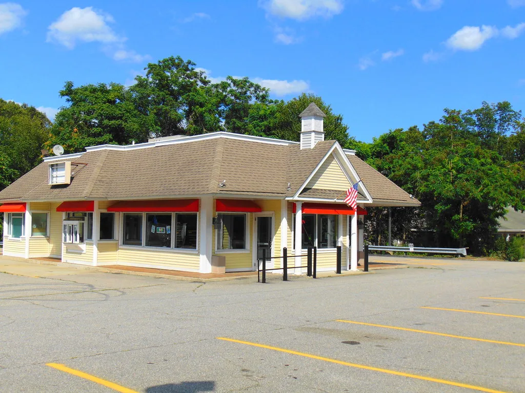 Former Tim Hortons cafe in North Stonington with a yellow facade and red awnings.