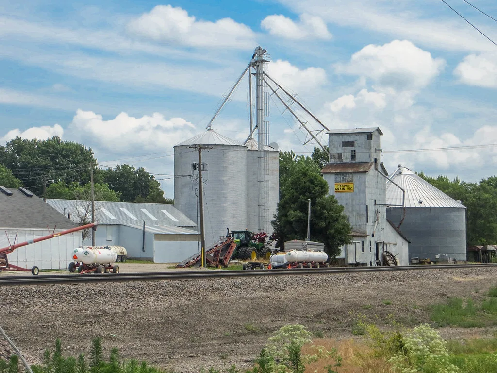 Grain elevator in Batavia, Iowa, beyond railway tracks.