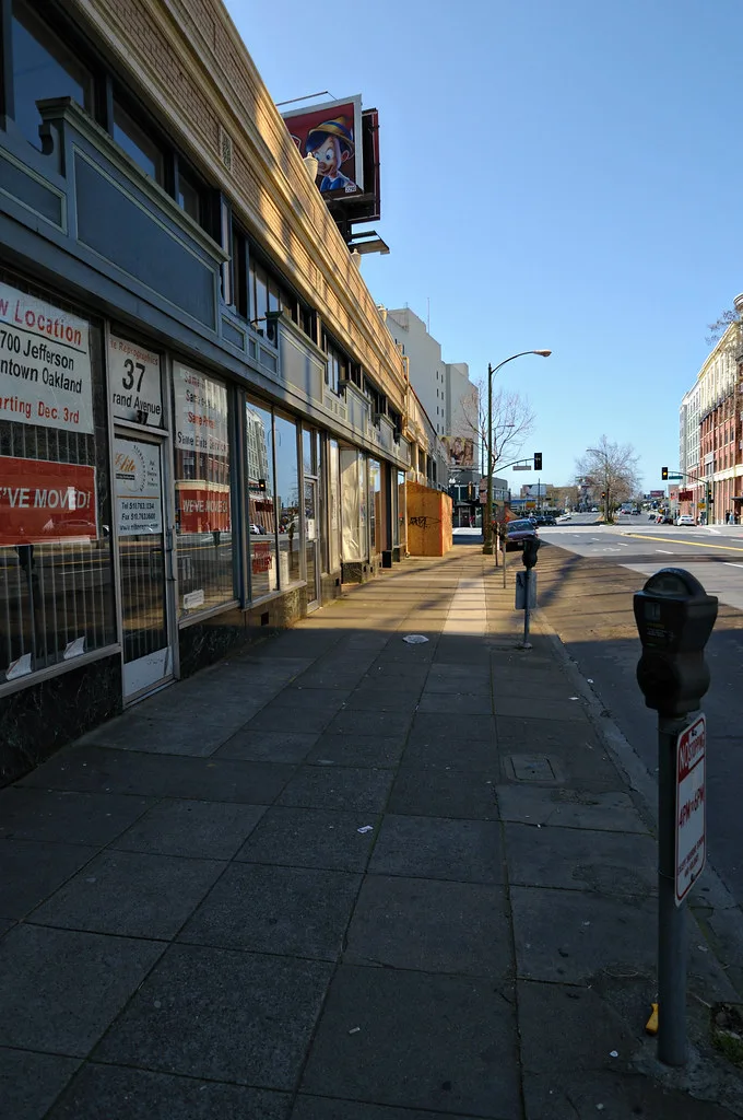 Facade of a former shop at 37 Grand along an urban sidewalk.