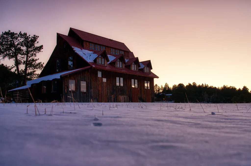 Historic Alderfer Ranch barn in snow at dusk