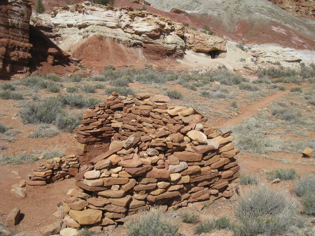 Circular dry-stone remains on arid ground.