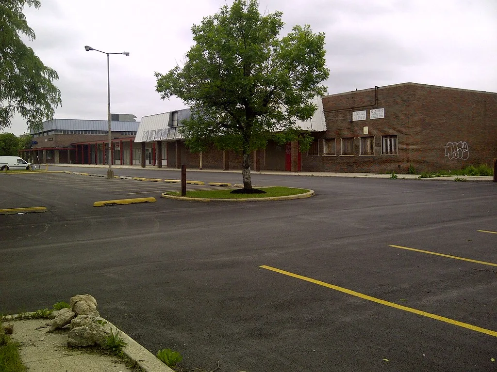 Shop fronts at the 51st and State shopping center facing an empty parking lot.