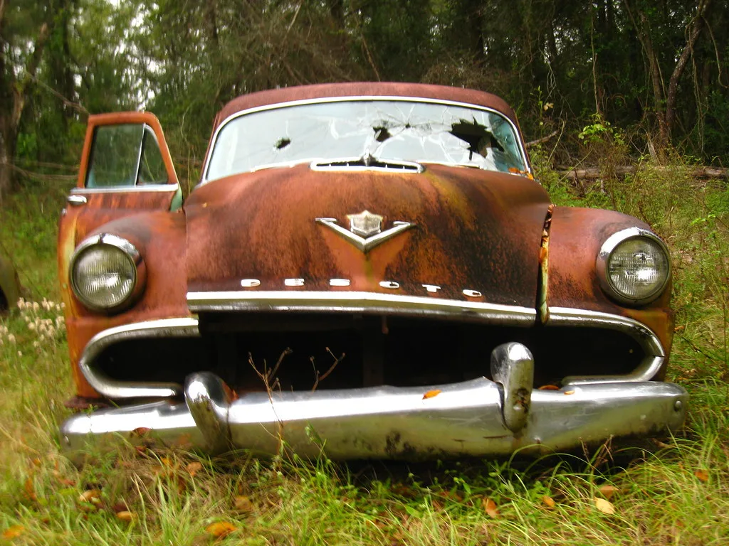 Rusting DeSoto wreck in a derelict vehicle field near Crawfordville