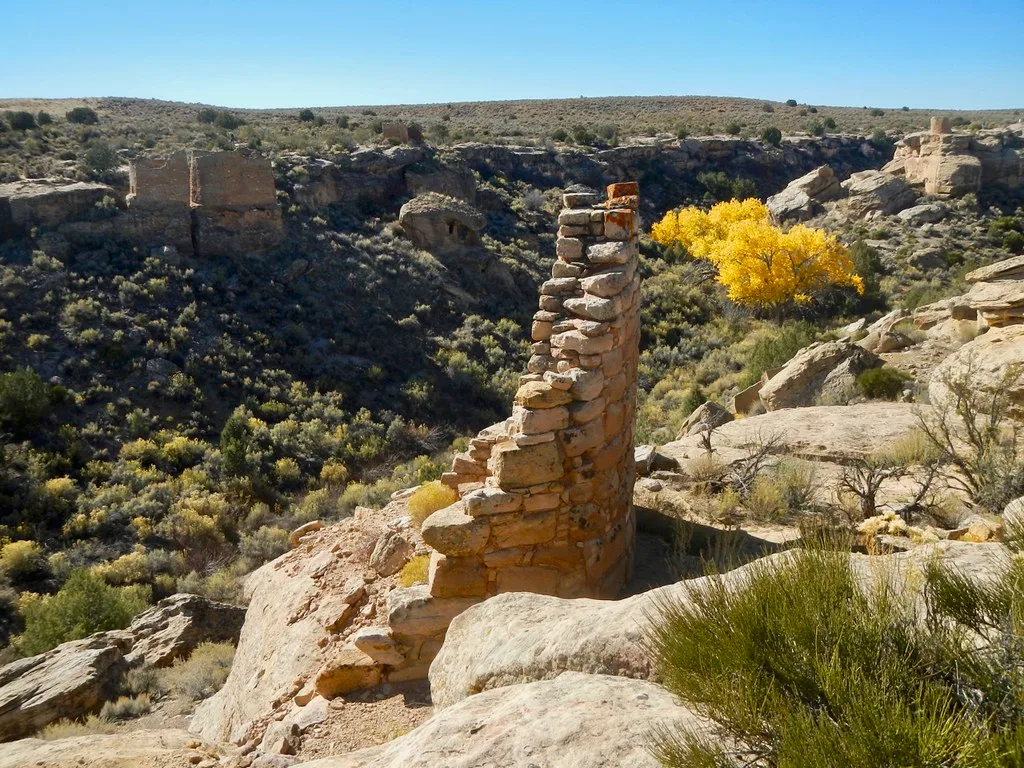 Remnant of a stone wall on a slope overlooking a canyon.