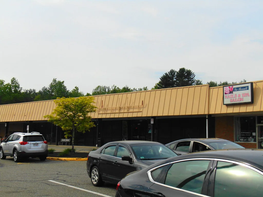 Former shop unit with its sign removed in a small shopping centre.