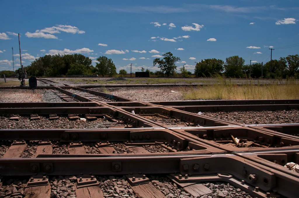 Crossing railway tracks at Pullman Junction beneath a blue sky.