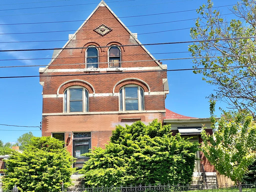 Brick house with a tall gable on Madison Avenue in Covington.