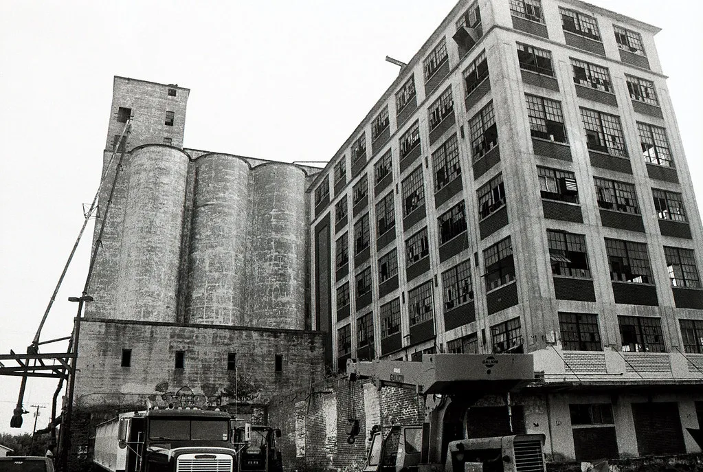 Old factory and concrete silos with broken windows.