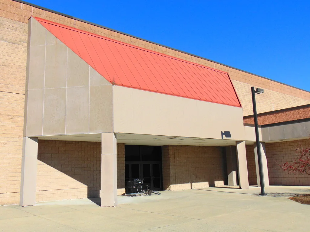 Entrée de l'ancien magasin Sears du Crystal Mall, sous un auvent rouge.