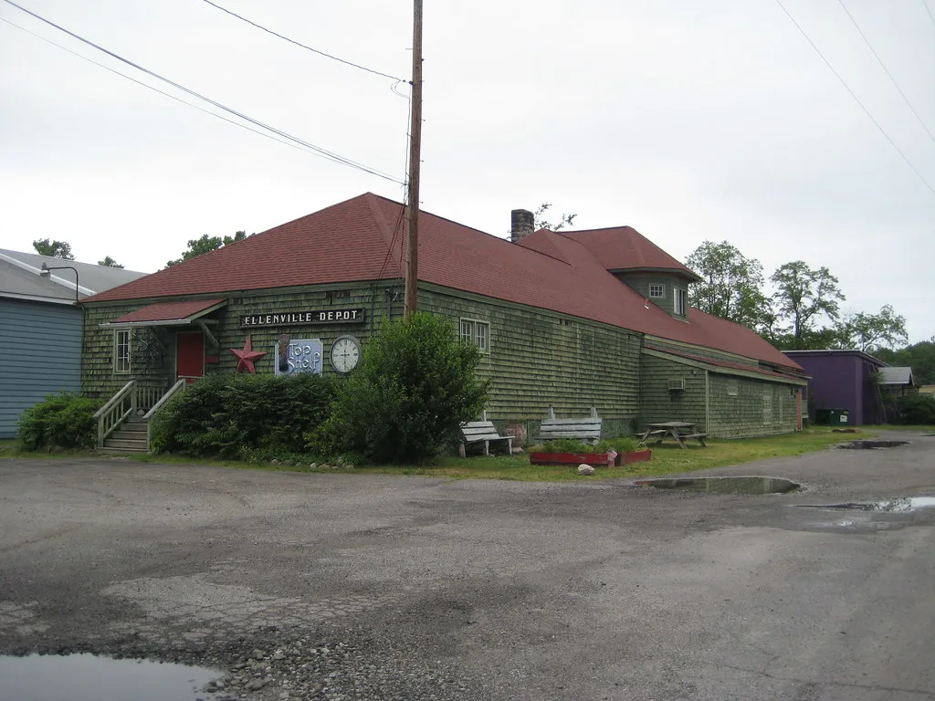 Former Ellenville station, a timber building with a broad red roof.