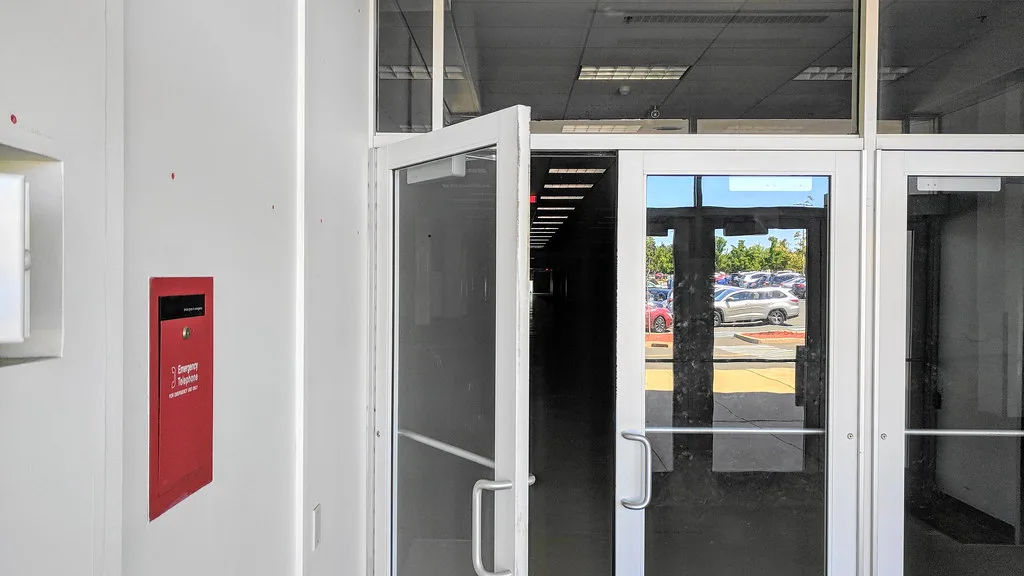 Glass doors opening into an empty shop interior.