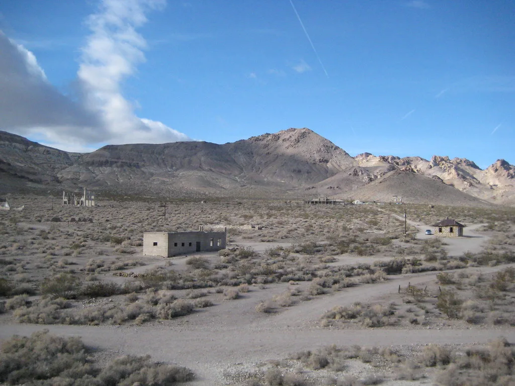 Scattered building ruins in a mountainous desert landscape.