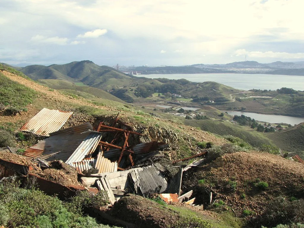 Collapsed structure on a hill overlooking a bay.