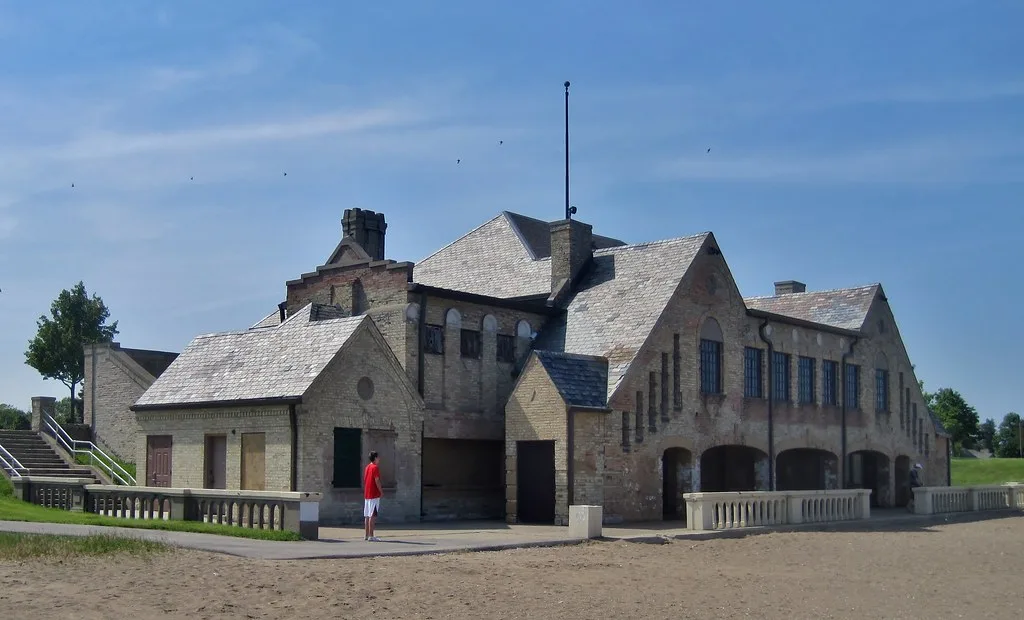 Southport Beach House in Kenosha with gables and arches beside the beach.