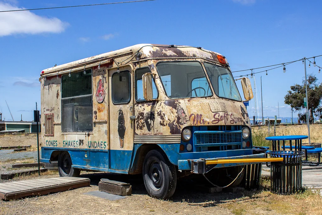Old ice-cream truck with rusty bodywork and peeling paint