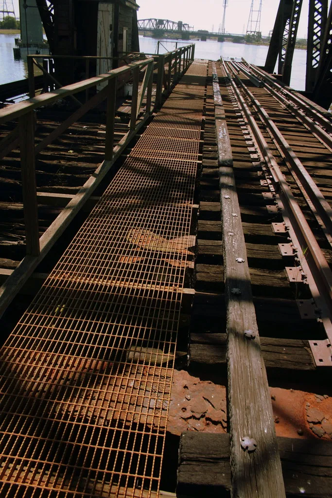 Old rusted railway deck above the water.