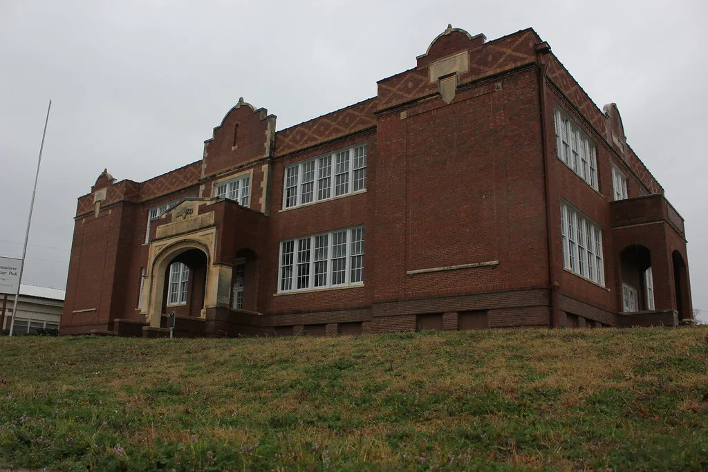 Former Mineral Wells high school in red brick, seen from the lawn.
