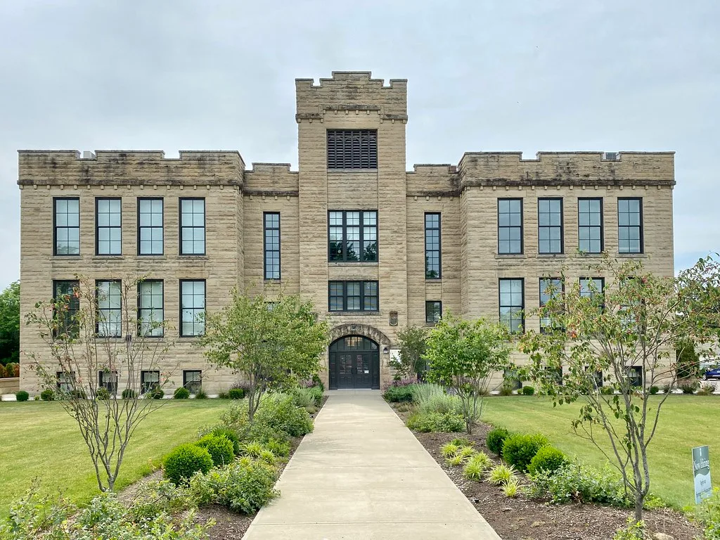 Stone facade and crenellated tower of the old Central School in Amherst.