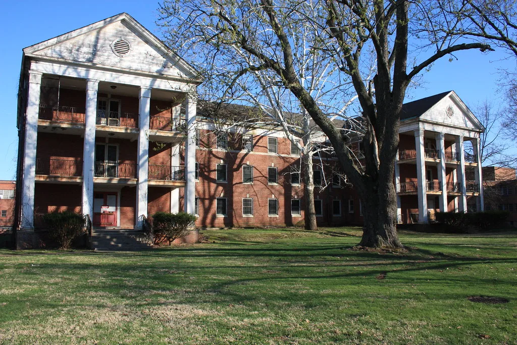 Abandoned building at Norristown State Hospital with two white columned porticoes.