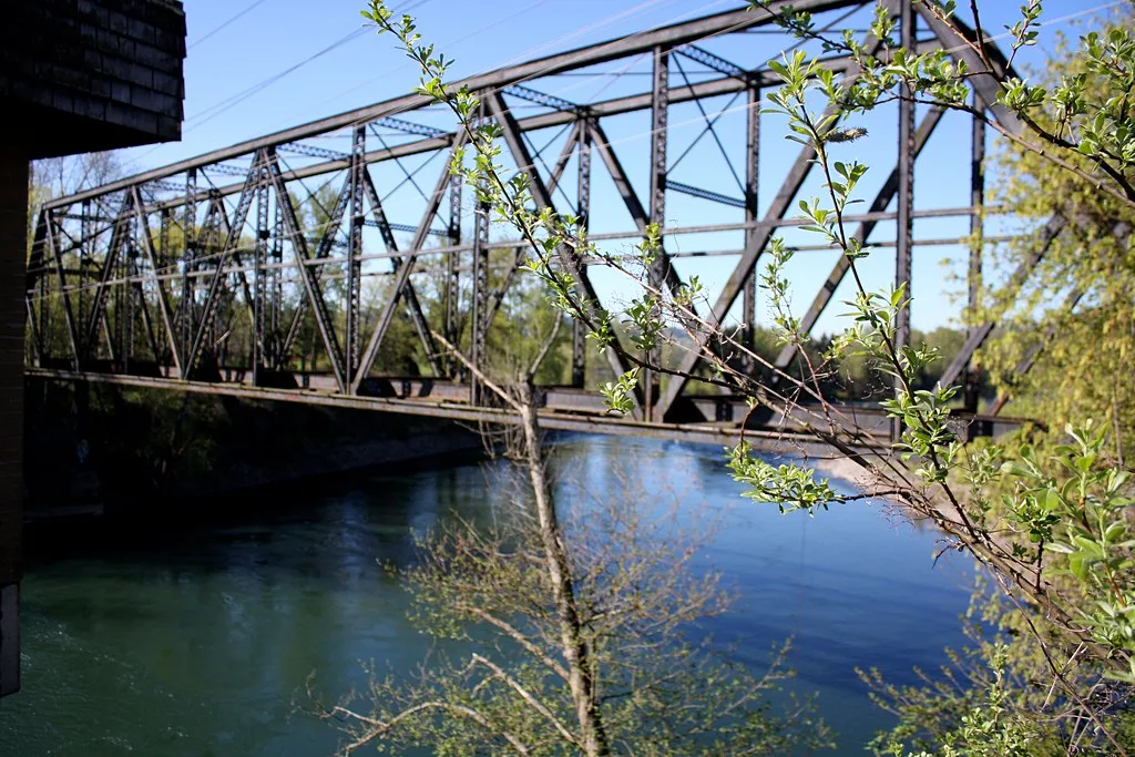 Old steel truss bridge over a river.