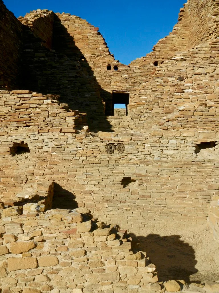 Ruined old stone walls with small openings.