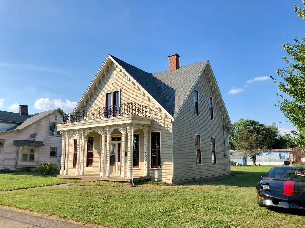 Rumpe House in Rising Sun with an ornate porch and tall gables.