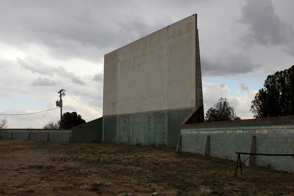 Old outdoor cinema screen on disused ground.