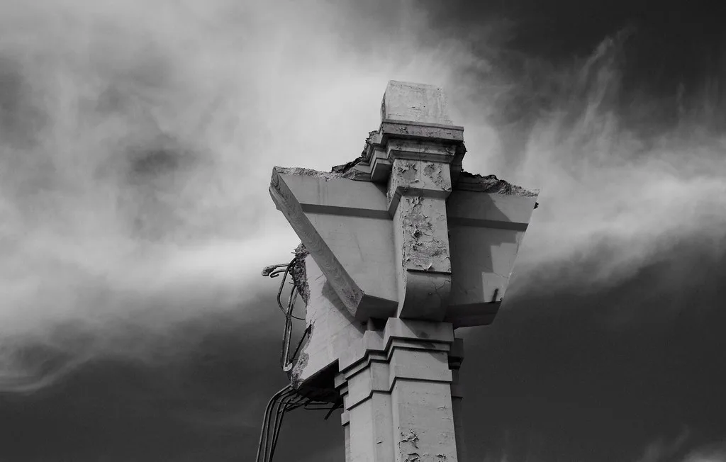 Broken top of a concrete pillar with exposed reinforcement.